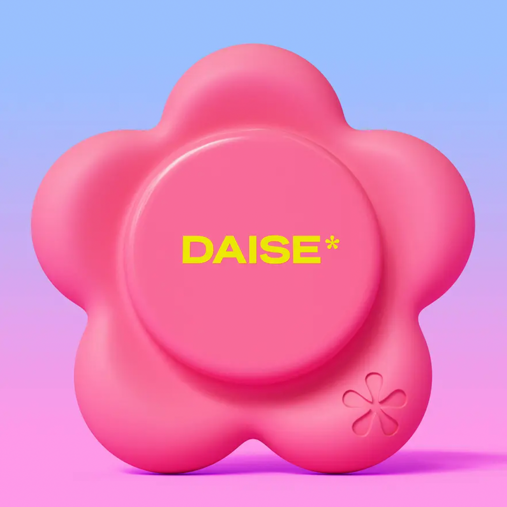 A pink flower-shaped product with a smooth matte finish, featuring the brand name 'DAISE*' in yellow text on the center and a small embossed flower detail in the lower right, set against a blue-to-pink gradient background.