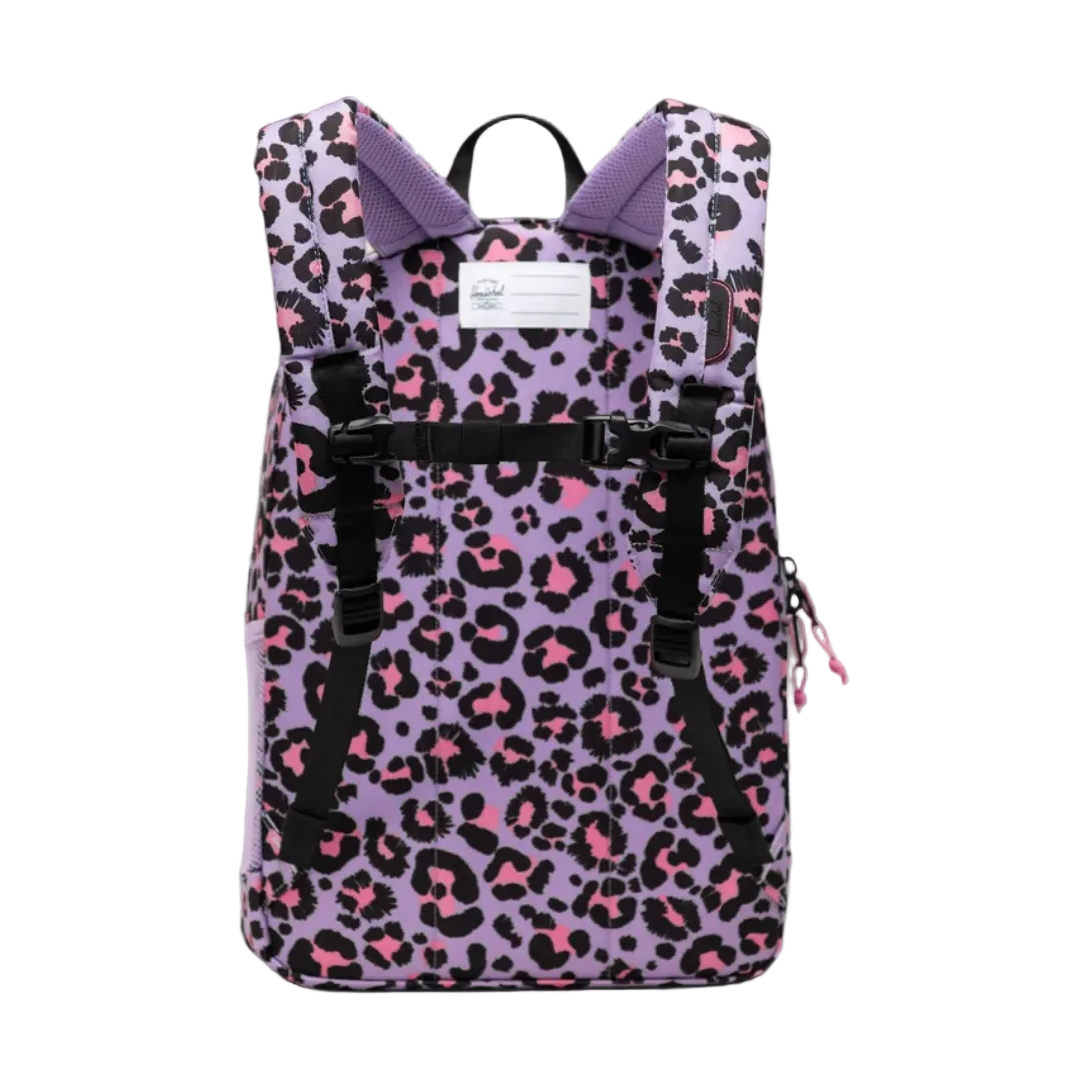 A purple backpack with a pink and black leopard print pattern, featuring a purple collar, black straps, and a white brand label on a gray gradient background.