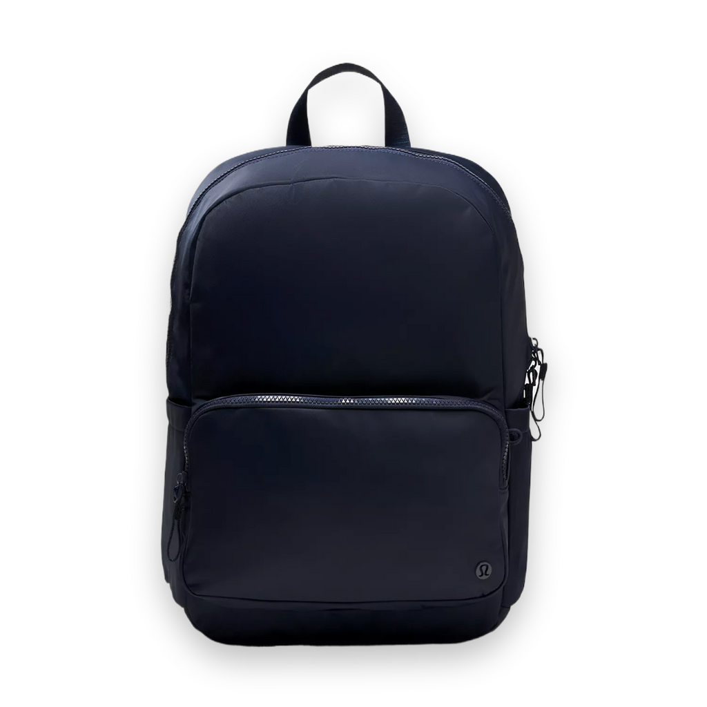 A dark navy blue nylon backpack with a top carry handle, a front zippered pocket, and side pockets, shown against a light gray studio background.