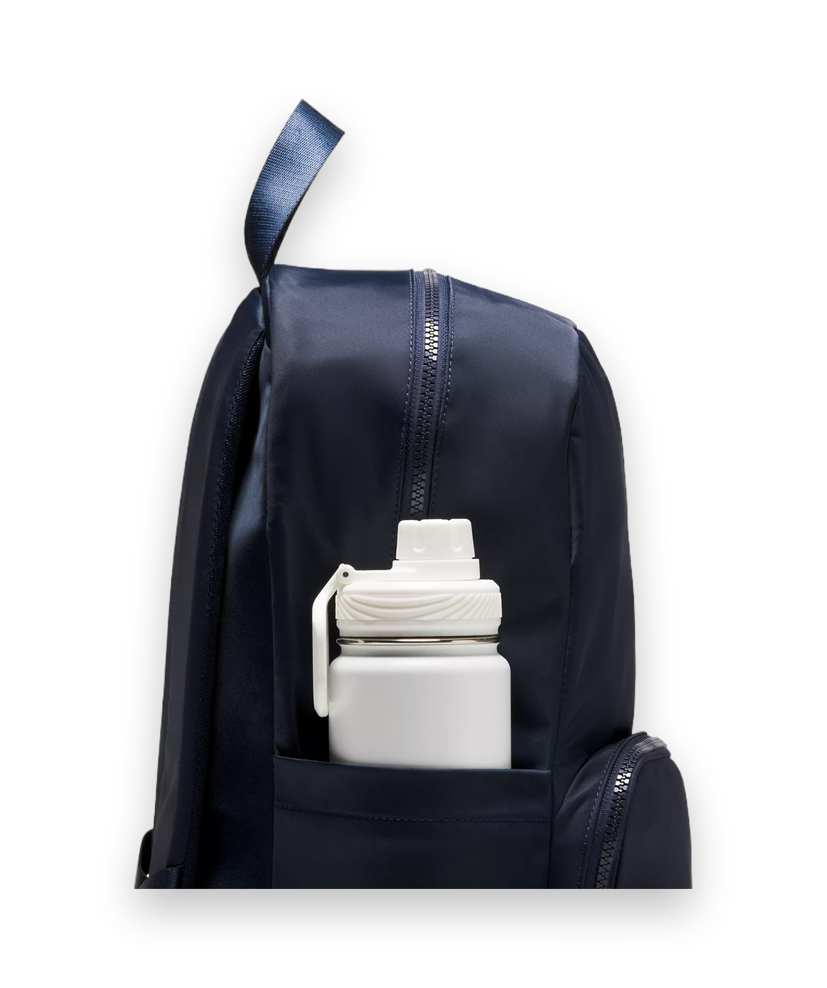 A close-up of a navy blue backpack with a front pocket holding a white insulated water bottle, shown against a light gray studio background.